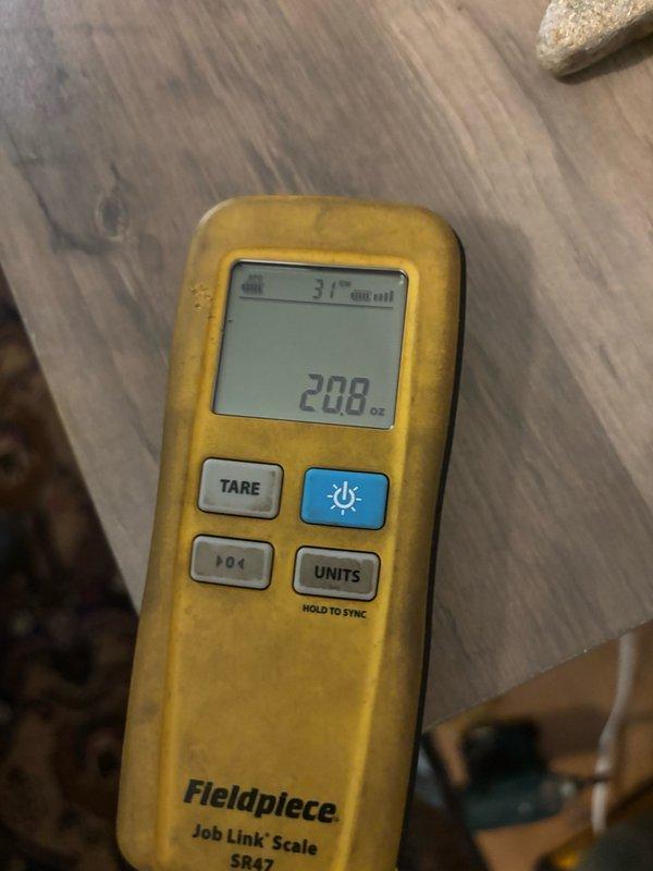Responded to no cooling complaint and performed diagnostic evaluation of HVAC system. Upon inspection, found system low on refrigerant charge as indicated by manifold gauge readings showing subnormal pressures. Verified compressor operation and checked electrical components at control board. Measured refrigerant charge using calibrated digital scale, which displayed 208 ounces remaining in system. Added refrigerant to manufacturer specifications and confirmed proper system operation with temperature differential readings showing adequate cooling performance restored.