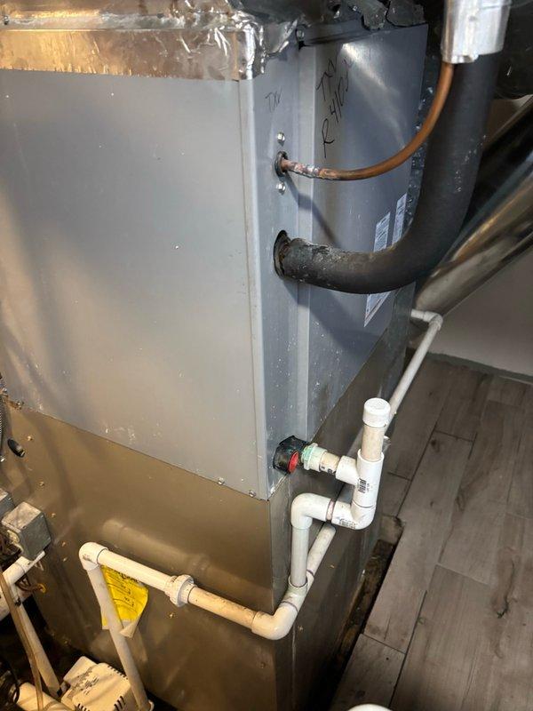 Responded to service call for reported air handler leak. Upon arrival, inspected HVAC system and cleared condensate drain line of debris and buildup. After thorough examination of the unit, condensate system, and surrounding PVC drain lines, determined that the condensate drainage was not the source of the reported leak. Photographed installation for documentation and further diagnostic evaluation may be required to identify actual leak source.