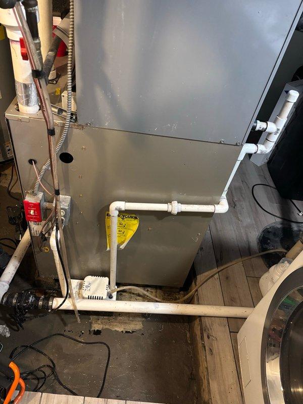 Responded to service call for reported air handler leak. Upon arrival, inspected HVAC system and cleared condensate drain line of debris and buildup. After thorough examination of the unit, condensate system, and surrounding PVC drain lines, determined that the condensate drainage was not the source of the reported leak. Photographed installation for documentation and further diagnostic evaluation may be required to identify actual leak source.