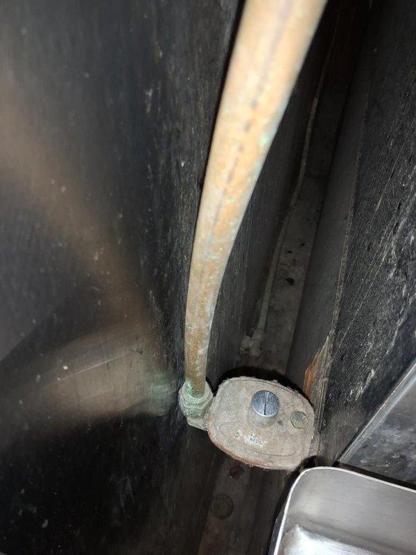 Conducted comprehensive walkthrough of gas piping installation to assess remaining work required for project completion. Documented existing mechanical systems including pump assembly, PVC piping configurations, and aging gas line components showing significant corrosion on mounting hardware and deterioration of pipe surfaces requiring attention before final system activation.