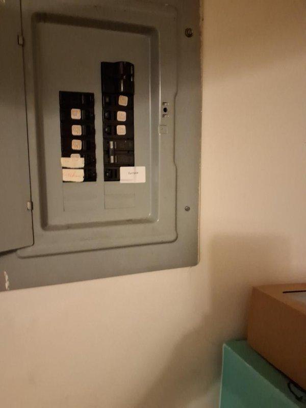 Conducted inspection of furnace electrical system and identified code violation with undersized disconnect switch box serving the heating equipment. Documented electrical panel configuration and emergency gas burner switch installation with photographs showing copper gas lines, PVC condensate drainage, and current electrical service setup for compliance review and necessary corrections.