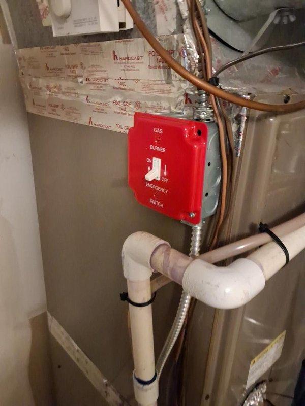 Conducted inspection of furnace electrical system and identified code violation with undersized disconnect switch box serving the heating equipment. Documented electrical panel configuration and emergency gas burner switch installation with photographs showing copper gas lines, PVC condensate drainage, and current electrical service setup for compliance review and necessary corrections.
