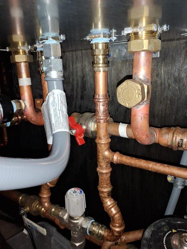 Responded to no hot water complaint and successfully replaced the flow sensor manifold on the water heating system. The faulty flow sensor was preventing proper hot water delivery, and after installing the new manifold assembly and verifying all electrical connections and plumbing fittings, the system was restored to full operation with hot water flow confirmed.