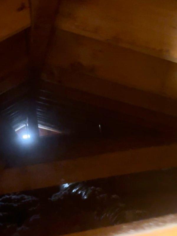 Responded to service call regarding unusual sound originating from ductwork system. Conducted thorough inspection of attic space and examined all accessible ductwork, including black flexible ducting, copper refrigerant lines, and associated mechanical components. Inspected wooden framing, insulation, and pipe fittings for any loose connections or contact points that could generate noise. Unable to replicate or locate the reported sound during inspection period. Documented attic conditions with photographs showing ductwork routing, insulation placement, and structural components for future reference if issue recurs.