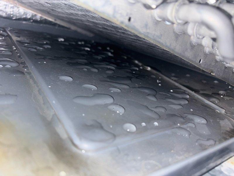 # No Cooling - Frozen Evaporator Coil

Responded to no cooling complaint and found evaporator coil completely frozen with heavy ice buildup and icicle formations. Coil exhibited significant dirt and debris accumulation restricting airflow. Identified frozen condensation throughout unit with water droplets present on multiple metal surfaces and components. System shut down to allow ice to thaw. Heavy soiling on coil fins indicated restricted airflow as primary cause of freezing condition. Recommended thorough coil cleaning and airflow verification once thaw complete to restore proper cooling operation and prevent recurrence.