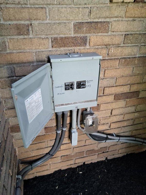 Conducted on-site evaluation for mini split system relocation and additional unit installation. Assessed existing Fujitsu mini split condenser currently positioned on concrete pad alongside conventional HVAC equipment, reviewed electrical service panel and conduit routing on exterior brick wall, and identified optimal placement options for relocated unit and new system addition. Documented current installation conditions including equipment positioning, electrical infrastructure, and available space for expanded mini split configuration.