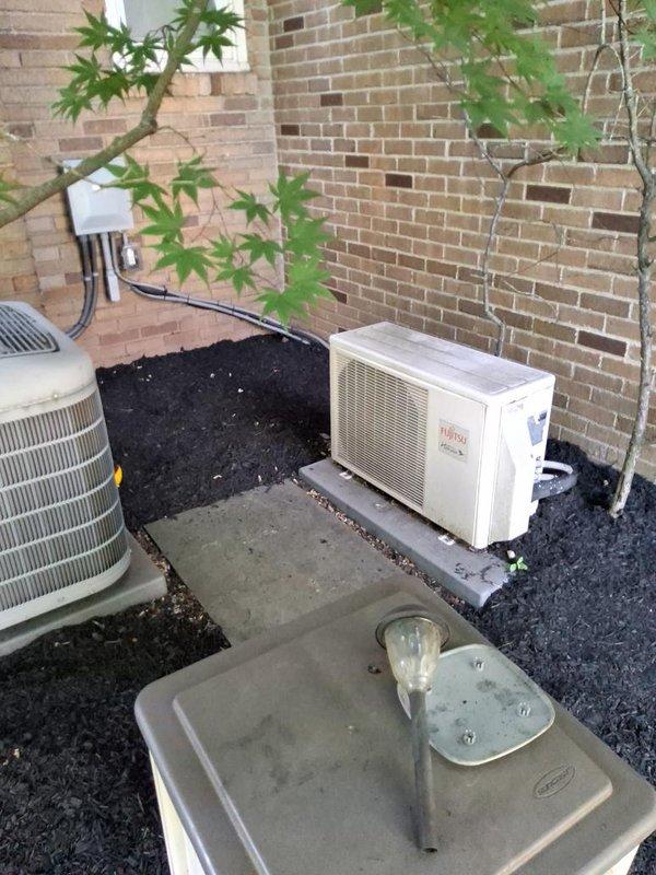 Conducted on-site evaluation for mini split system relocation and additional unit installation. Assessed existing Fujitsu mini split condenser currently positioned on concrete pad alongside conventional HVAC equipment, reviewed electrical service panel and conduit routing on exterior brick wall, and identified optimal placement options for relocated unit and new system addition. Documented current installation conditions including equipment positioning, electrical infrastructure, and available space for expanded mini split configuration.