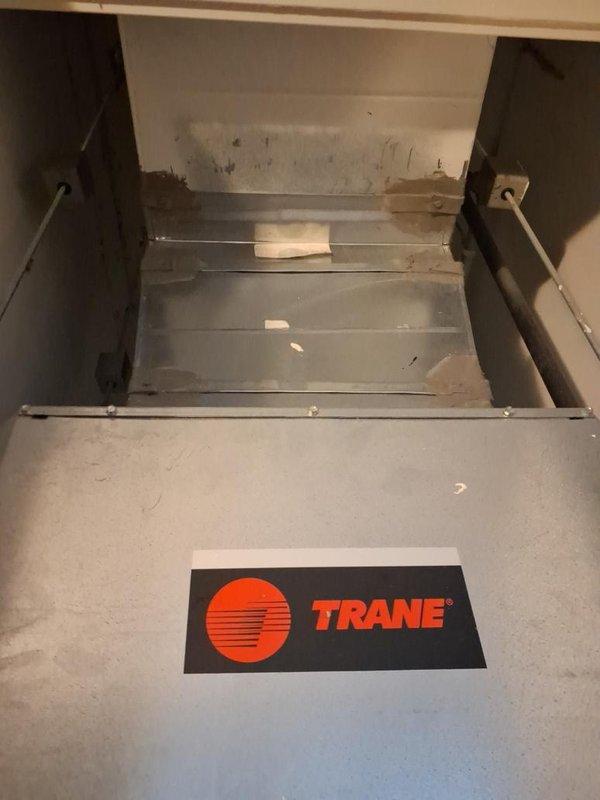 Responded to no cooling complaint on Trane air handler system. Upon arrival, performed diagnostic inspection of unit installed in interior closet location. Documented current system condition with interior and exterior cabinet photographs showing accumulated dust and debris within compartment. Assessed refrigerant lines, electrical connections, and overall unit operation to determine immediate serviceability. Provided temporary operational solution to maintain cooling function while customer pursues replacement equipment estimate.