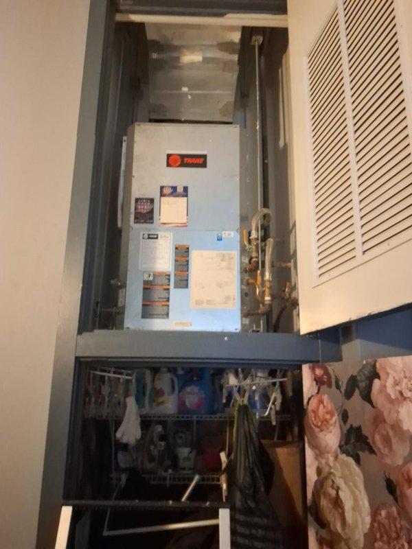 Responded to no cooling complaint on Trane air handler system. Upon arrival, performed diagnostic inspection of unit installed in interior closet location. Documented current system condition with interior and exterior cabinet photographs showing accumulated dust and debris within compartment. Assessed refrigerant lines, electrical connections, and overall unit operation to determine immediate serviceability. Provided temporary operational solution to maintain cooling function while customer pursues replacement equipment estimate.
