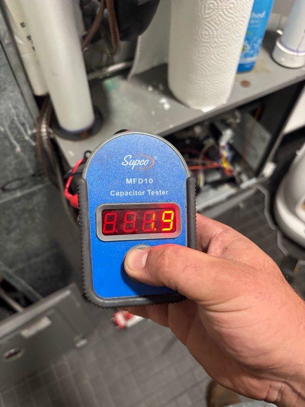 Picked up replacement blower wheel from supply house and installed new component in system. Tested capacitor readings with digital meter, confirming proper electrical values at 88.49 MFD after blower wheel replacement and verifying all HVAC components functioning correctly.