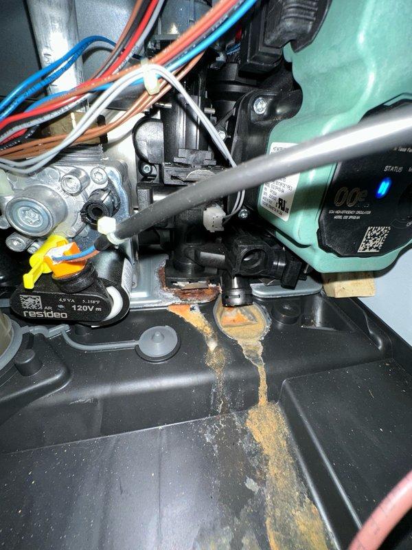 Responded to no hot water call involving indirect water heater system. Upon inspection, discovered significant corrosion and rust buildup on system components with evidence of active leaking. Circulator pump assembly showed moisture intrusion with brownish-orange fluid accumulation in base pan, indicating internal system contamination or corrosion byproduct. Assessed condition of pump, zone valves, and associated plumbing connections. Documented extensive rust damage on metal surfaces and mineral scale deposits suggesting prolonged water exposure. System requires component replacement and further evaluation to restore hot water functionality.