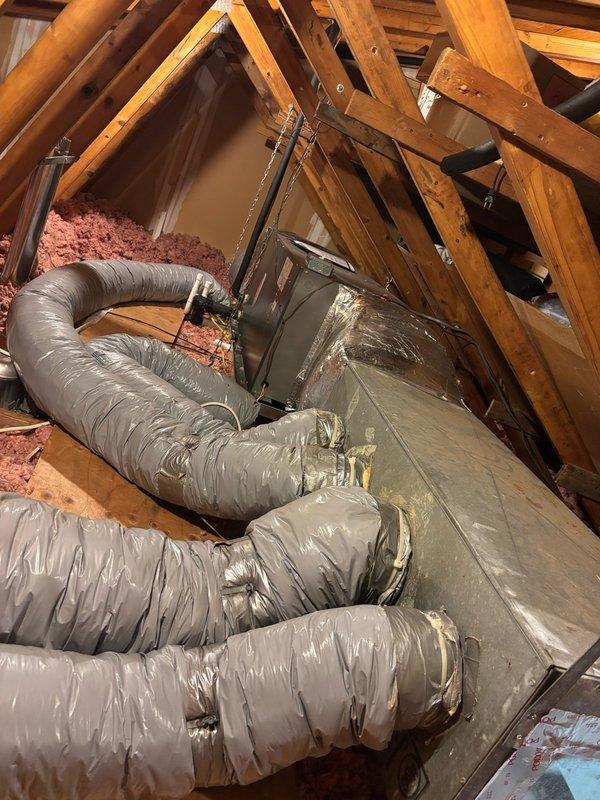 Completed comprehensive antimicrobial duct cleaning service for residential HVAC system. Accessed attic space using ladder to service air handler unit and extensive flexible ductwork system, removing accumulated dust, debris, and particulate matter from blower wheel assembly, interior ductwork surfaces, and system components. Applied antimicrobial treatment throughout the duct system to inhibit future microbial growth and improve indoor air quality.