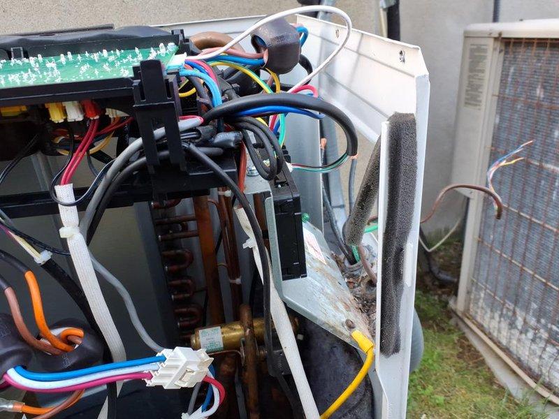 Replaced defective condenser fan motor and main PCB on outdoor HVAC unit. Unit interior showed significant wear with corroded base platform and oxidized refrigerant lines, though these components remained functional. All electrical connections were properly secured with new wiring harnesses, and system was tested to verify proper operation of new components.