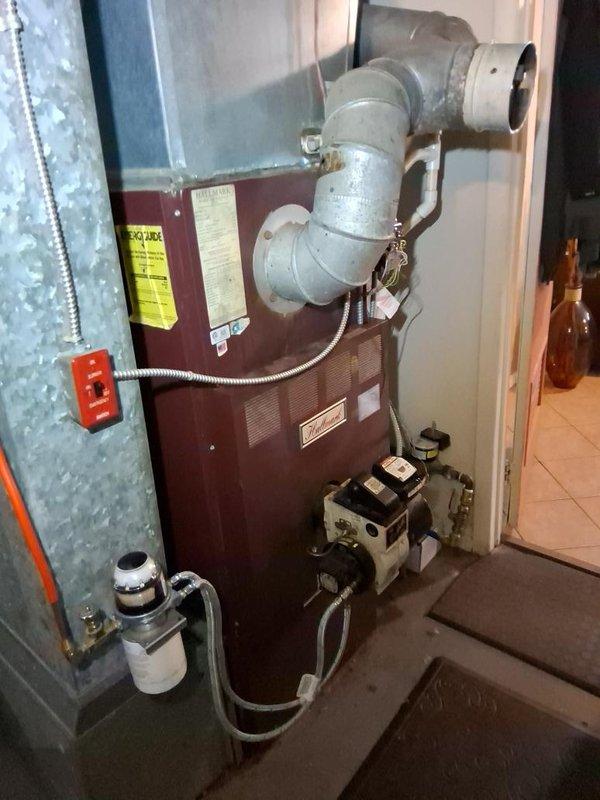Completed gas piping and venting installation for residential heating system. Installed new gas supply lines with proper shut-off valves, connected furnace unit with code-compliant black iron piping, and configured venting system using gray metal ductwork with appropriate elbow fittings to ensure safe exhaust of combustion gases. All connections were pressure tested and verified for proper operation.