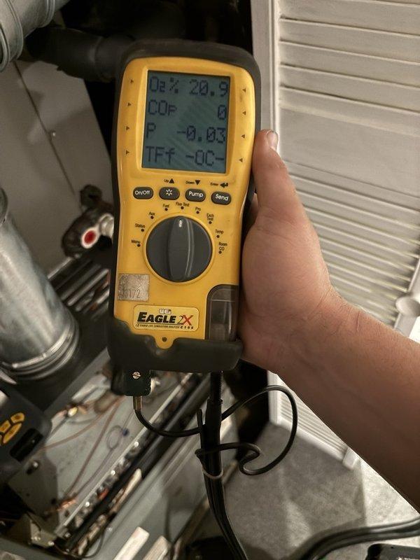 Completed comprehensive gas furnace maintenance and tune-up. Performed combustion analysis testing using digital analyzer, measuring oxygen levels at 20.9% and CO readings to ensure safe and efficient operation. Conducted voltage testing on electrical components, recording 14.08V to verify proper power supply to control systems. Inspected heat exchanger, burner assembly, and all critical furnace components for safe operation and optimal performance.