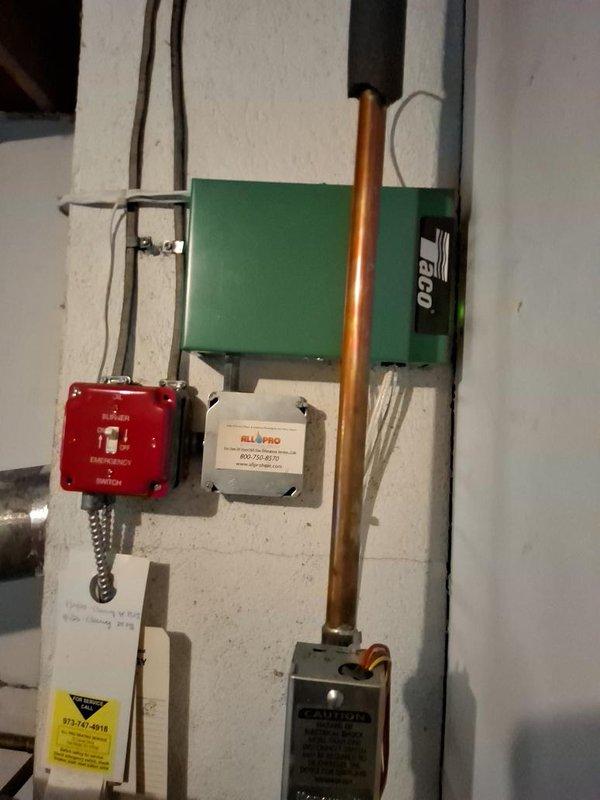 Conducted on-site assessment for oil-to-gas boiler conversion project scheduled through New Jersey Natural Gas utility program. Evaluated existing oil-fired heating system including current boiler configuration, copper piping distribution network, circulator pumps, electrical service capacity, and venting infrastructure. Documented existing mechanical room layout with attention to electrical panel location, hydronic piping arrangements with multiple zone valves and manifolds, and current oil burner control systems including Riello burner assembly and emergency shut-off switches. Photographed HVAC ductwork connections and existing flue pipe routing to determine gas boiler installation requirements and necessary modifications for proper venting and combustion air supply.