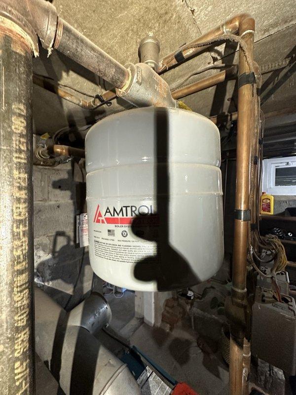 Completed oil burner maintenance and tune-up on residential heating system. Performed comprehensive inspection of teal oil burner unit, associated copper piping, AMTROL expansion tank, and all system components to ensure proper operation and efficiency for the upcoming heating season.
