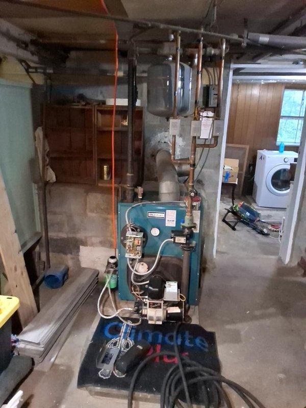 Completed oil burner maintenance and tune-up on residential heating system. Performed comprehensive inspection of teal oil burner unit, associated copper piping, AMTROL expansion tank, and all system components to ensure proper operation and efficiency for the upcoming heating season.