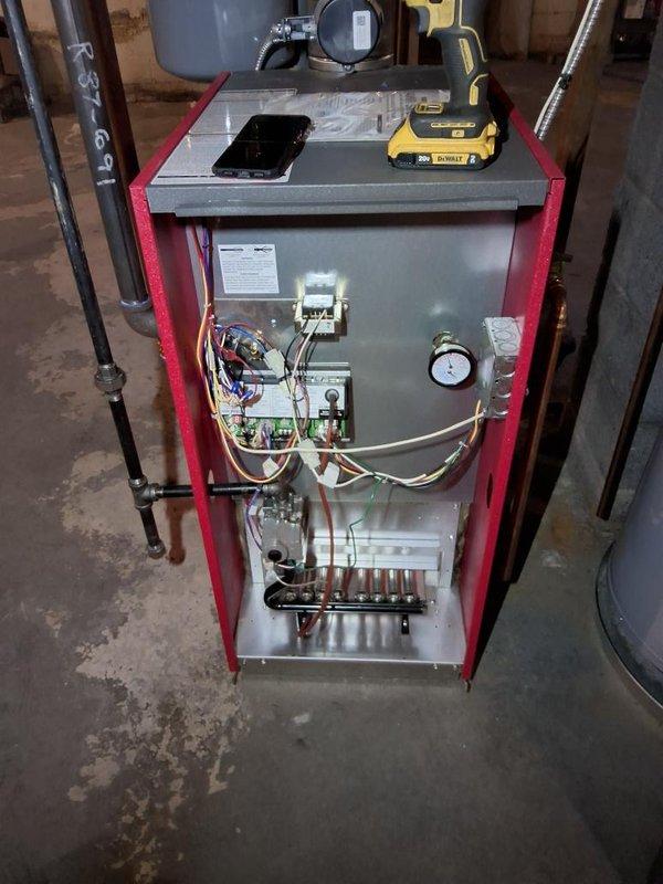 Performed annual gas heating maintenance on the boiler, removing the front panel to inspect the burner assembly, gas valve, control board wiring, and pressure/temperature gauge, with no signs of corrosion, leaks, or damage observed. Verified the hydronic zone valve actuators, circulator pump, and associated copper piping and manifold were in good condition and operating properly.