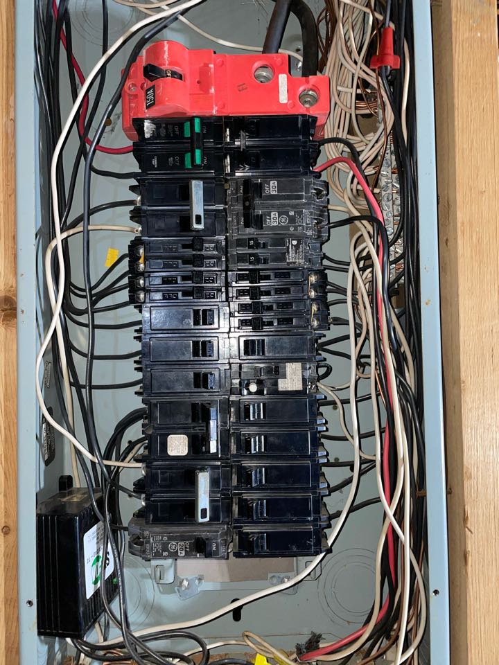 Electrician changing an old panel to a new panel