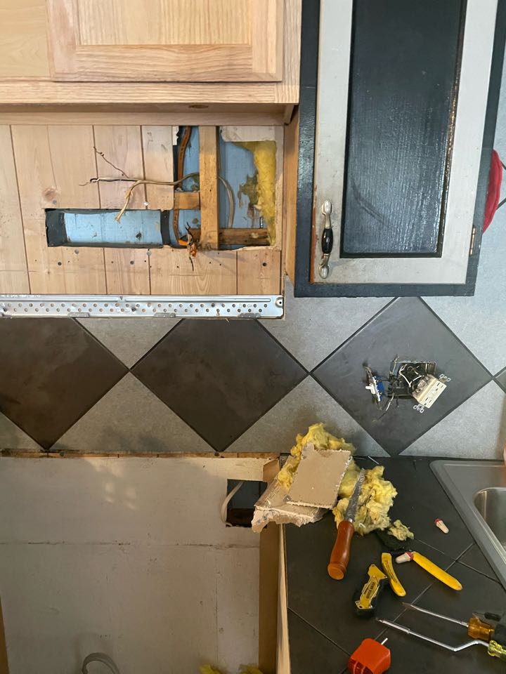 Electrician correcting some issues with the microwave and a relevant room circuit