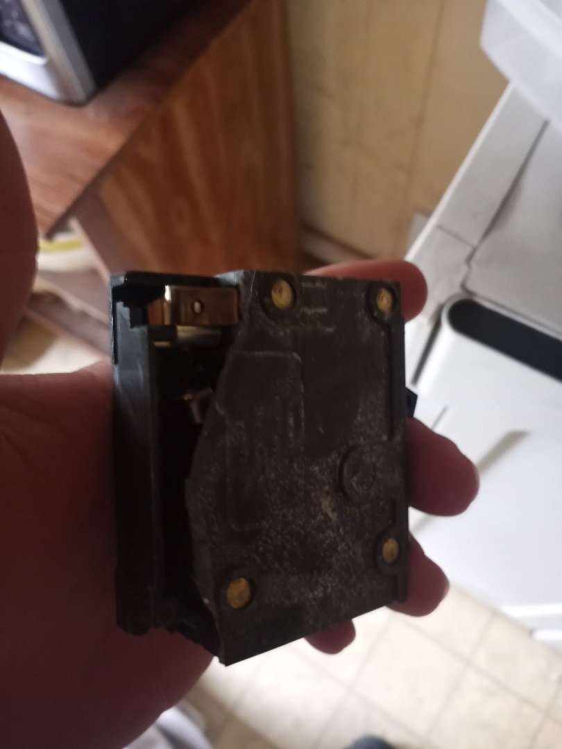 Electrician replacing faulty breaker