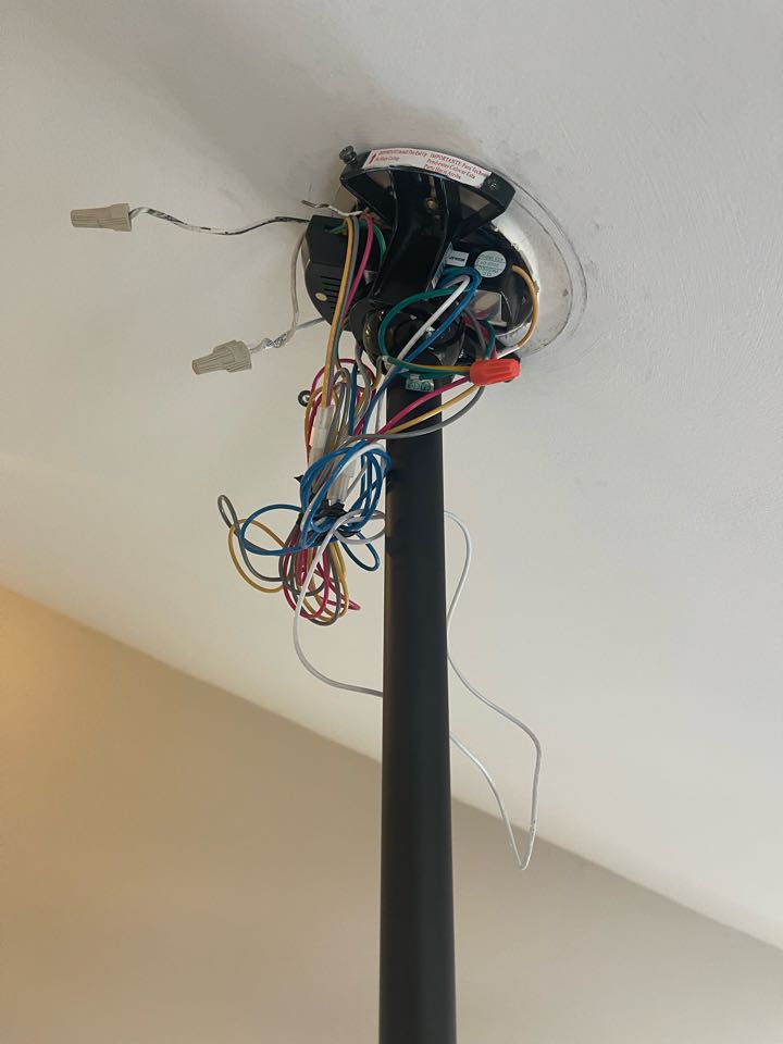 Electrician is installing customer supplied fan remote 