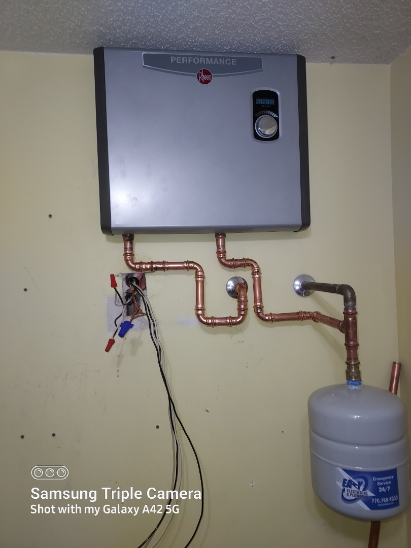 Plumber installing customer  supplied tankless water heater