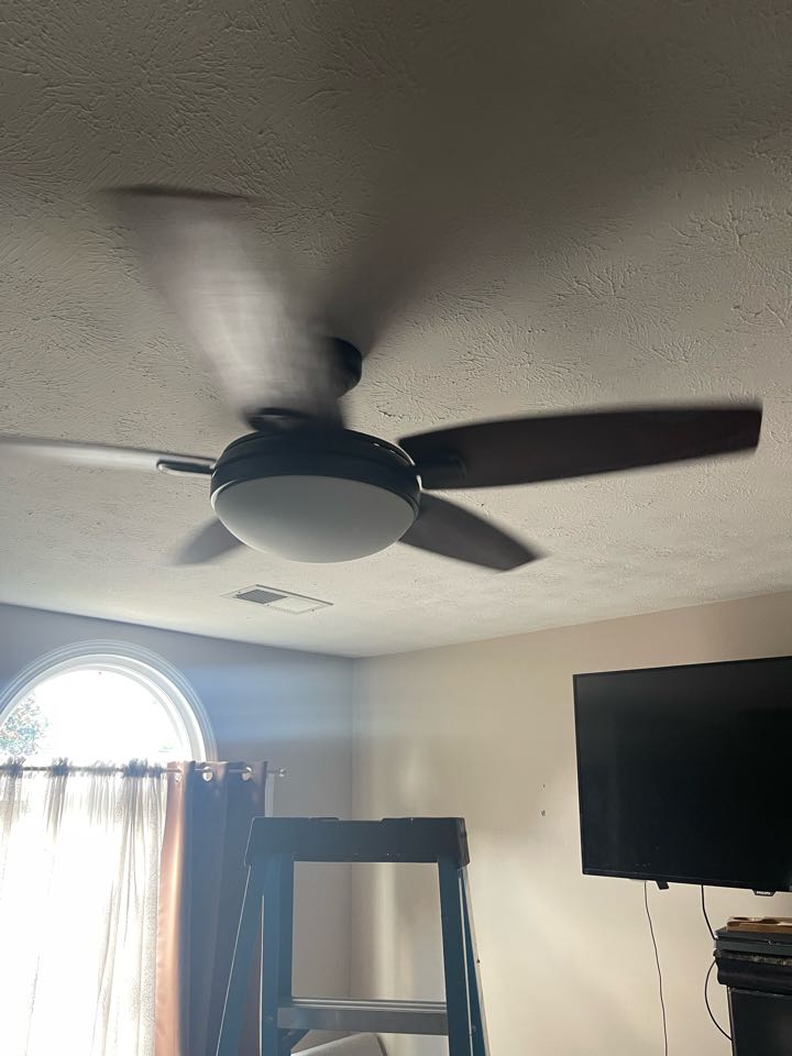 Electrician is installing a customer supplied ceiling fan 