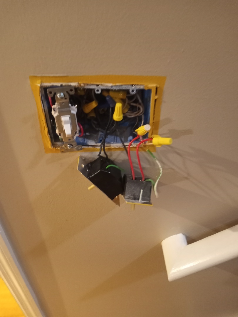 Electrician correcting wiring issue and switch box