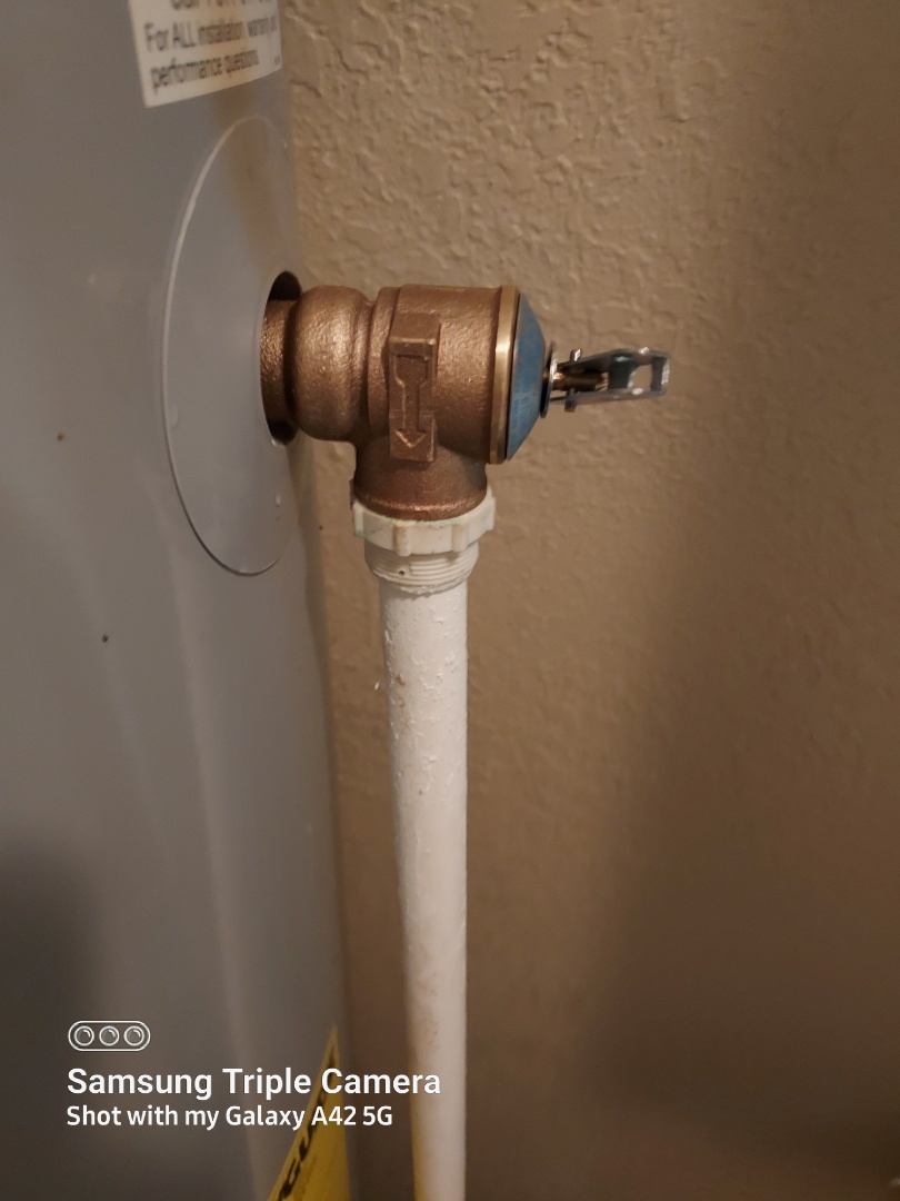 Plumber replacing relief valve on water heater