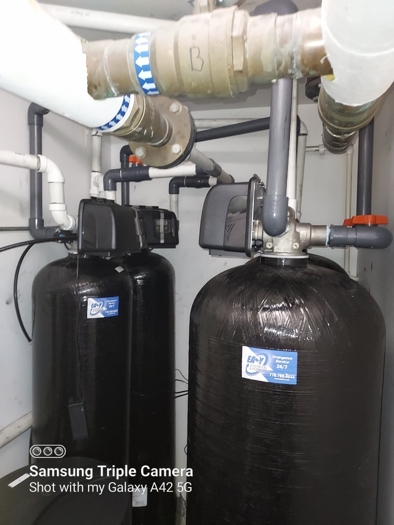 Plumber installing commercial water filters