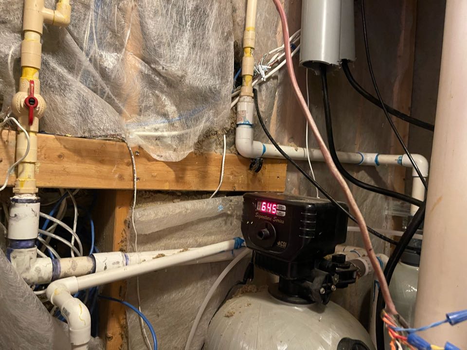 Plumber issuing an estimate for a new water filtration system and softener