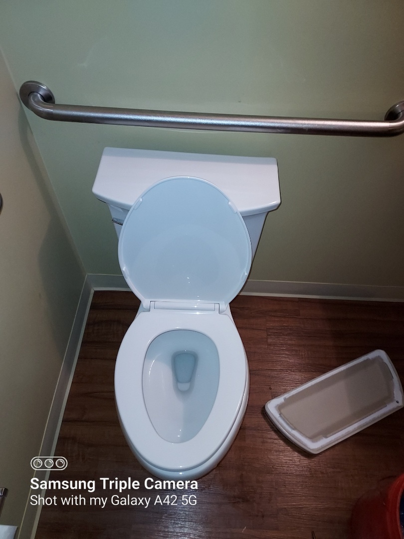 Plumber installing new toilet