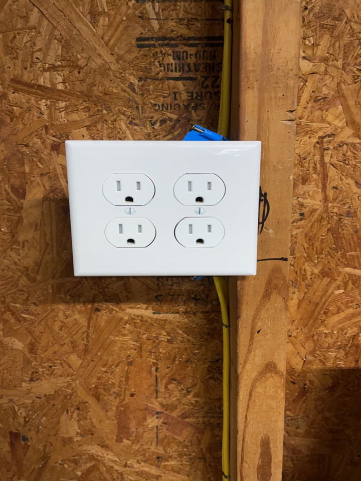 Electrician installing new wiring through out garage 