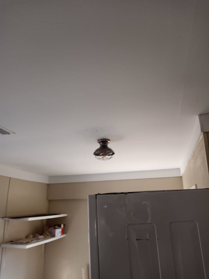 Electrician installing kitchen light