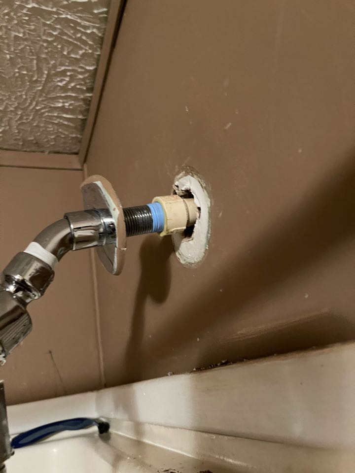 Plumber repairing shower water leak 