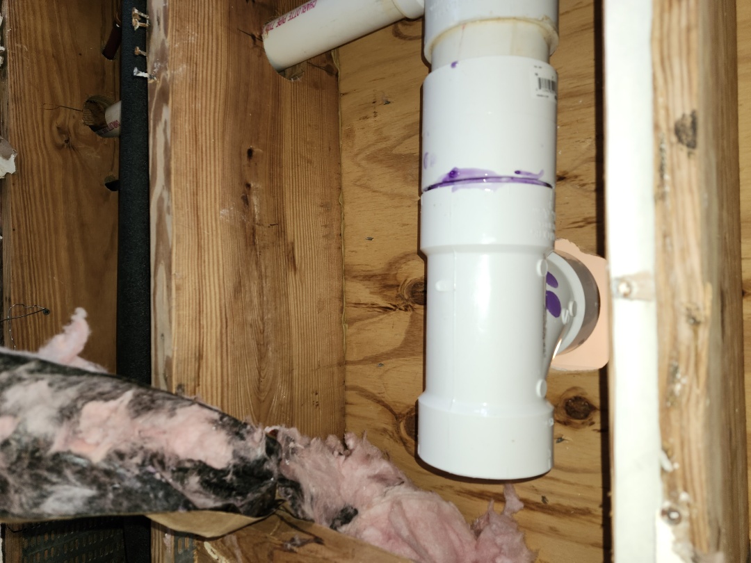 Replaced 3" sanitary tee in ceiling and set toilet. Flushed multiple times and inspected drain line.