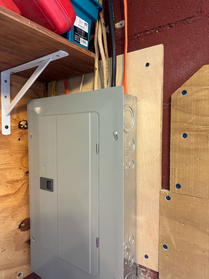 Electrician Installing subs panel in shed