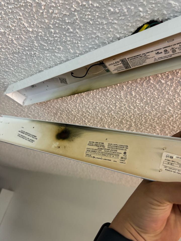 Electrician repairing light fixture. 