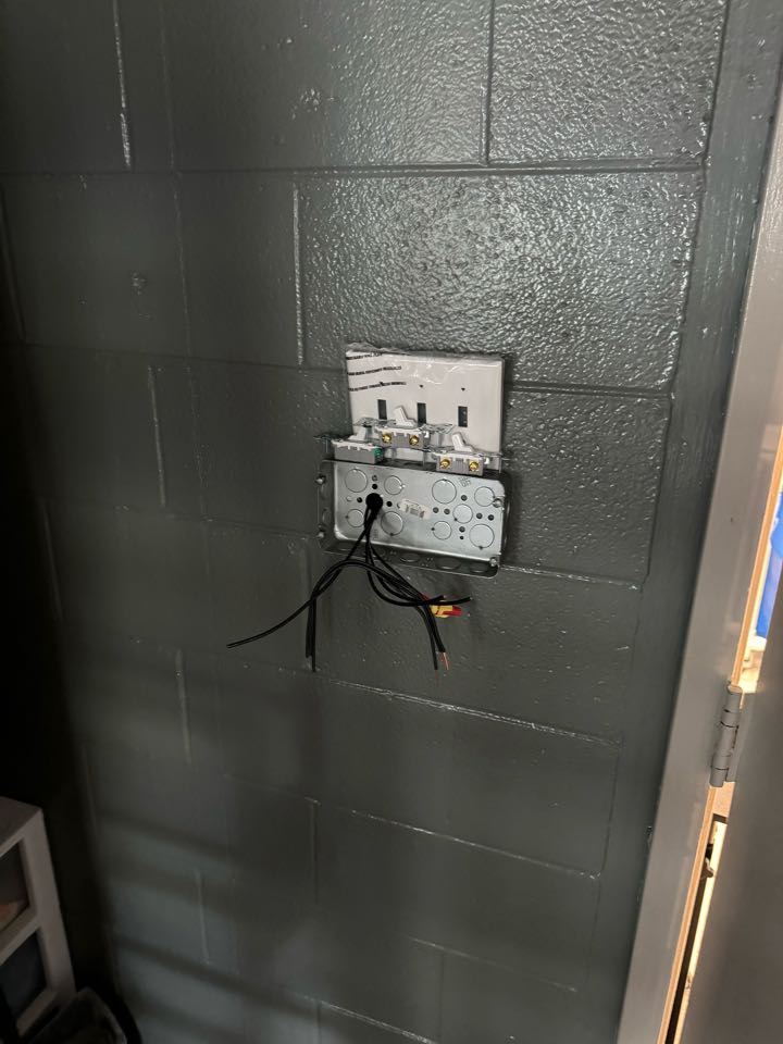 Electrician installing three and service mounted box to separate lighting from one switch to three switches. 