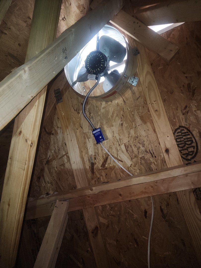 electrician installing attic fan