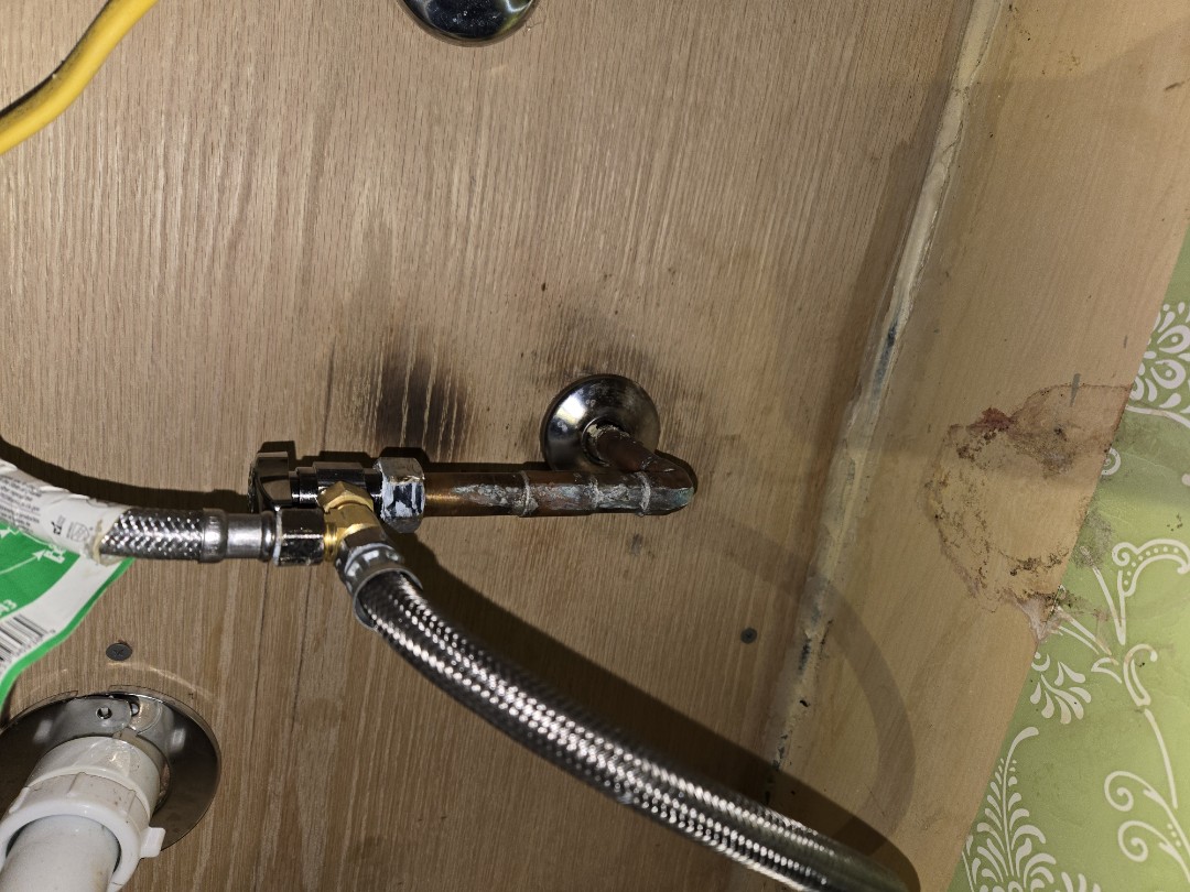 plumber replacing valve under the sink.