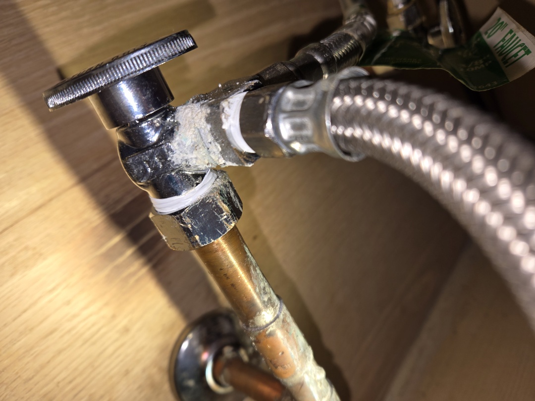plumber replacing valve under the sink.
