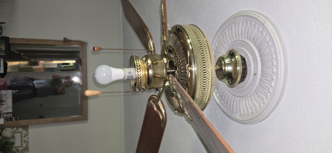 Electrician replacing fan in bedroom