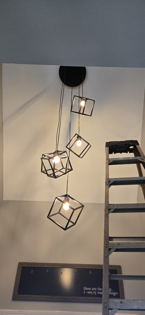 Electrician installing new light fixture