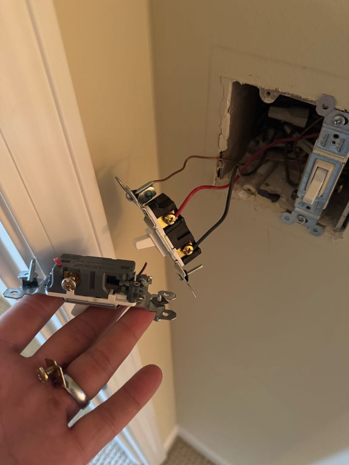 Electrician replacing switch