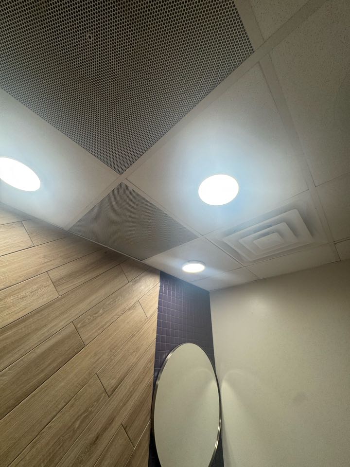 Electrician preparing light in bathroom