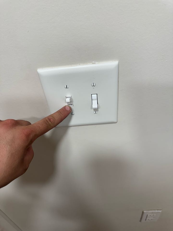 Electrician replacing light switch