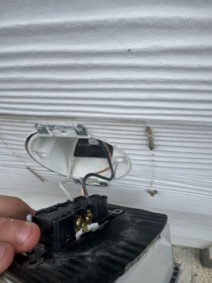 Electrician testing outlet